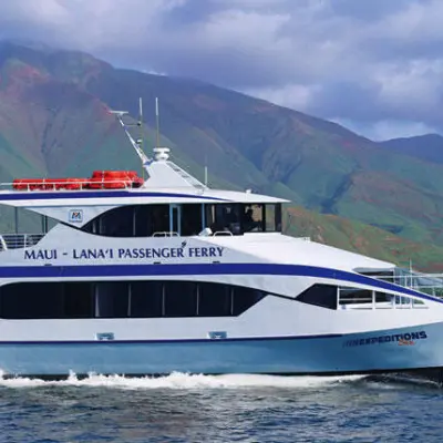 a small boat in a body of water with a mountain in the background