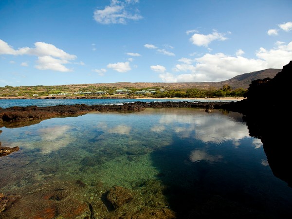 a body of water with a mountain in the background