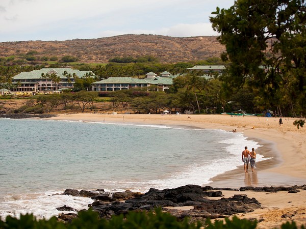 a group of people on a beach near a body of water