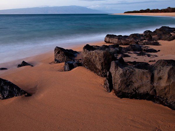 a rocky beach next to a body of water