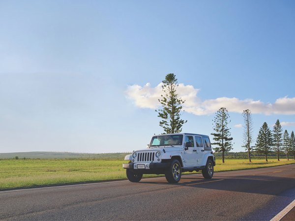 a truck driving down a dirt road